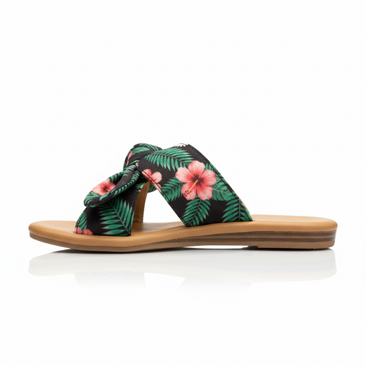 Side profile of tropical print slide sandals showing twisted knot height and comfortable flat silhouette