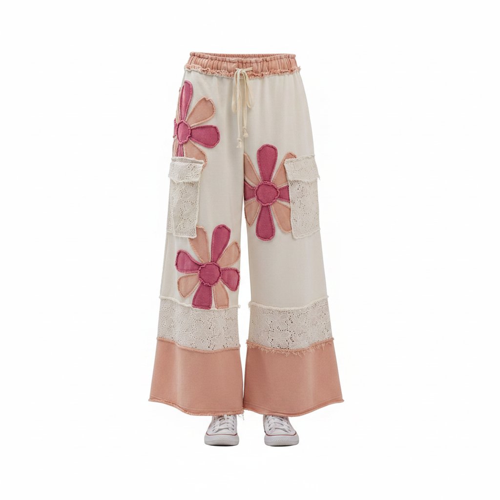 Women's cream wide-leg pants front, ghost mannequin, pink daisy appliqué, eyelet lace panels, ruched waistband