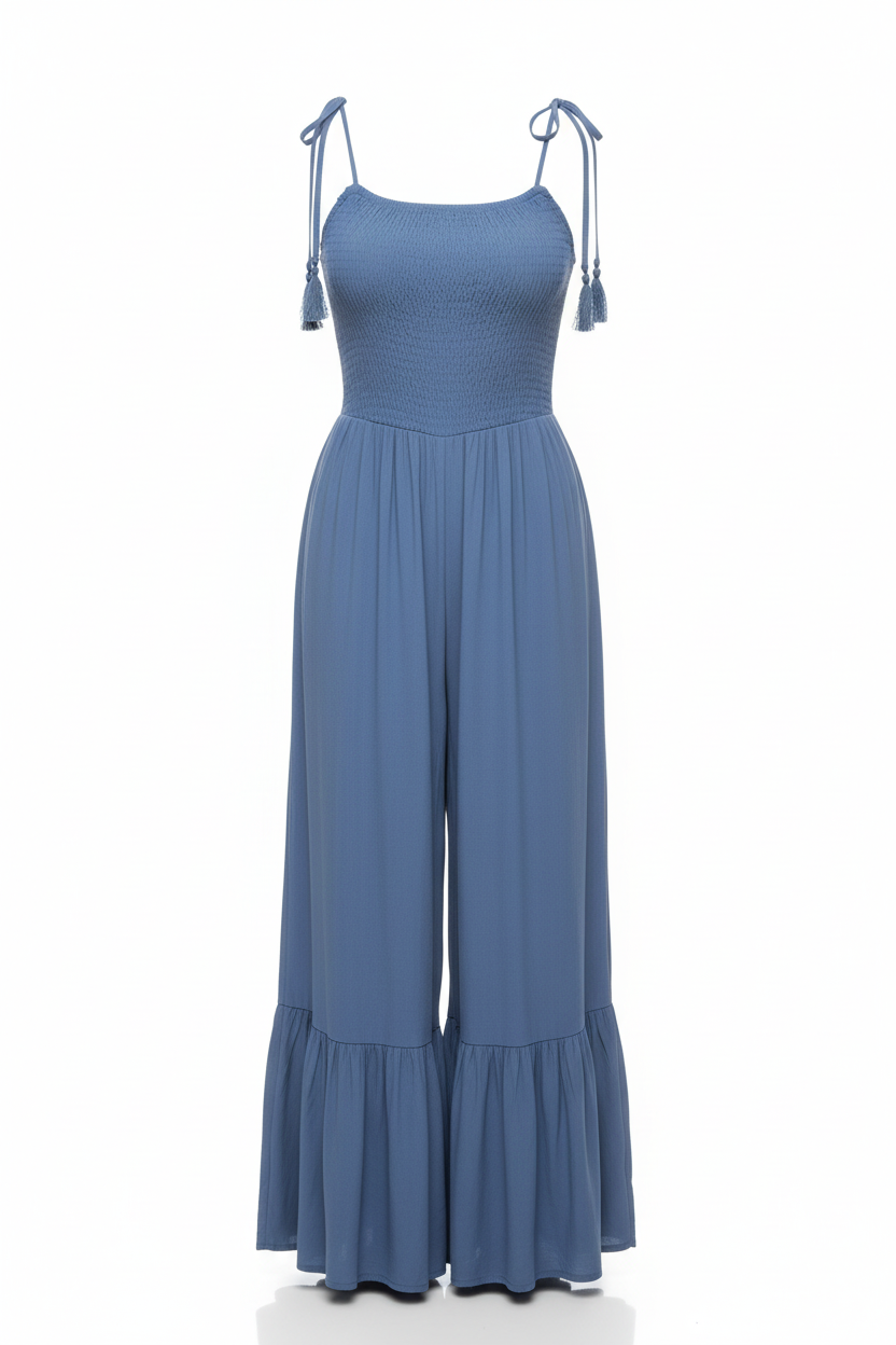 Smocked tie-strap ruffle jumpsuit in denim blue - front view showing wide-leg silhouette and adjustable straps