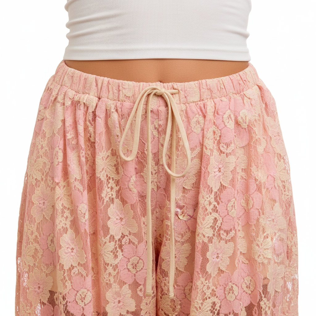 Women's peach floral lace pants waistband detail, cream drawstring tie, semi-sheer lace texture close-up