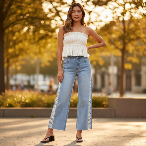Women's light blue wide leg crop jeans with flower lace side panels styled in outdoor golden hour setting - BellanBlue