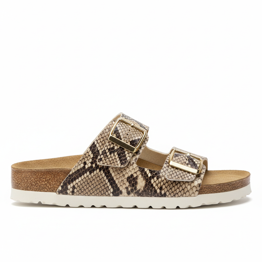 Snake print slide sandal side profile showing cork footbed height and black rubber sole thickness