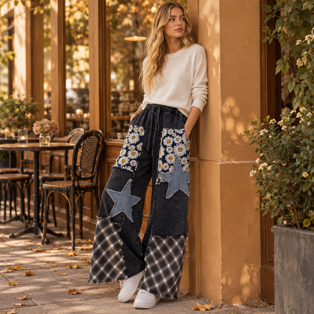 Sage + Fig women's patchwork wide-leg pants with denim stars and plaid hems outside a cafe