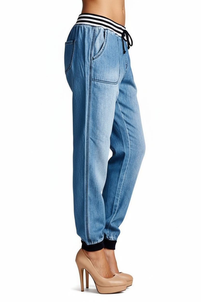 Light blue jeans with black stripes worn by a person on a white background