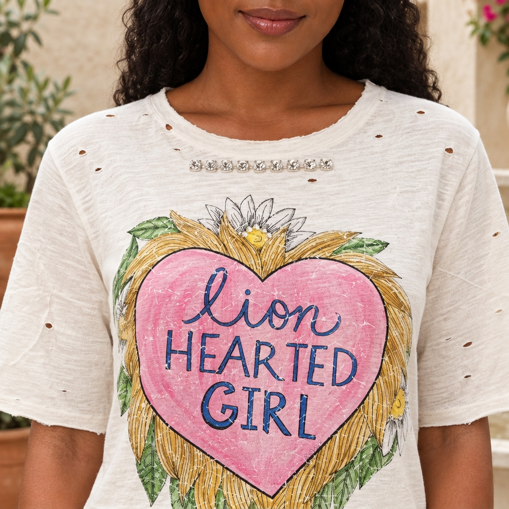 A Rare Bird Shop ivory Lion Hearted Girl tee close-up with extended sleeves, sparkling chest trim and distressed details
