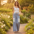 Women's denim blue eyelet ruffle high waist wide leg pants styled with white crop top and tan sandals boho spring outfit - BellanBlue