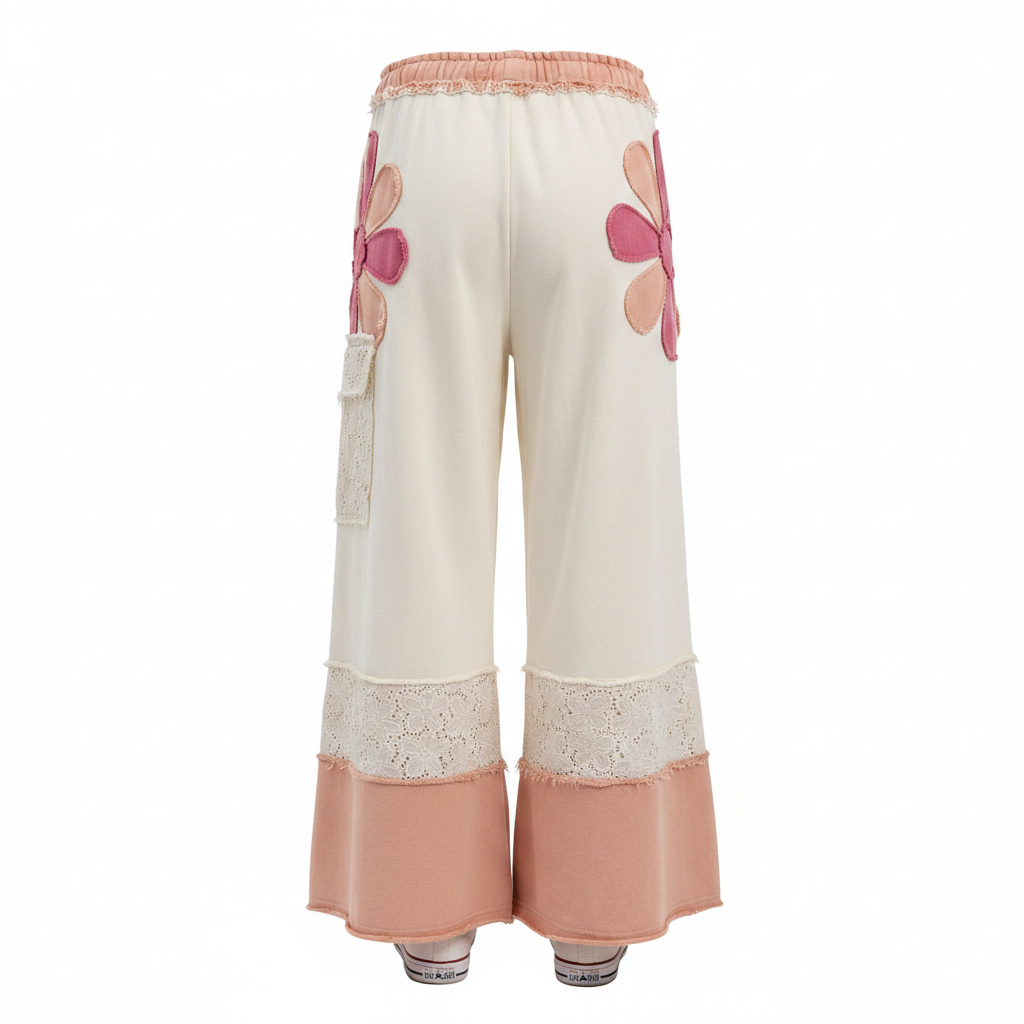 Women's ivory wide-leg pants back view, ghost mannequin, daisy flower patches, eyelet lace, peach hem panel