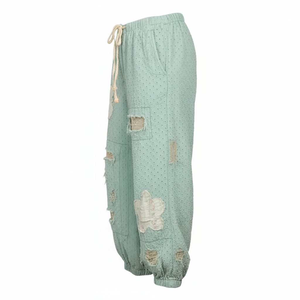 Women's mint polka dot wide-leg pants side profile showing distressed rips and side pocket detail