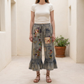 Blue Velvet women's denim patchwork ruffle-hem pants, front view in a cream courtyard - BellanBlue
