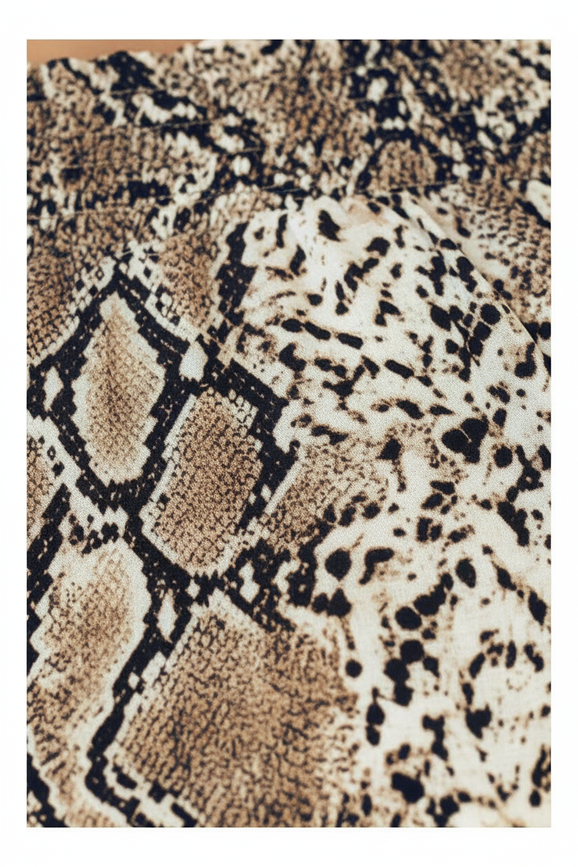 Close-up detail of snake print fabric texture and pattern