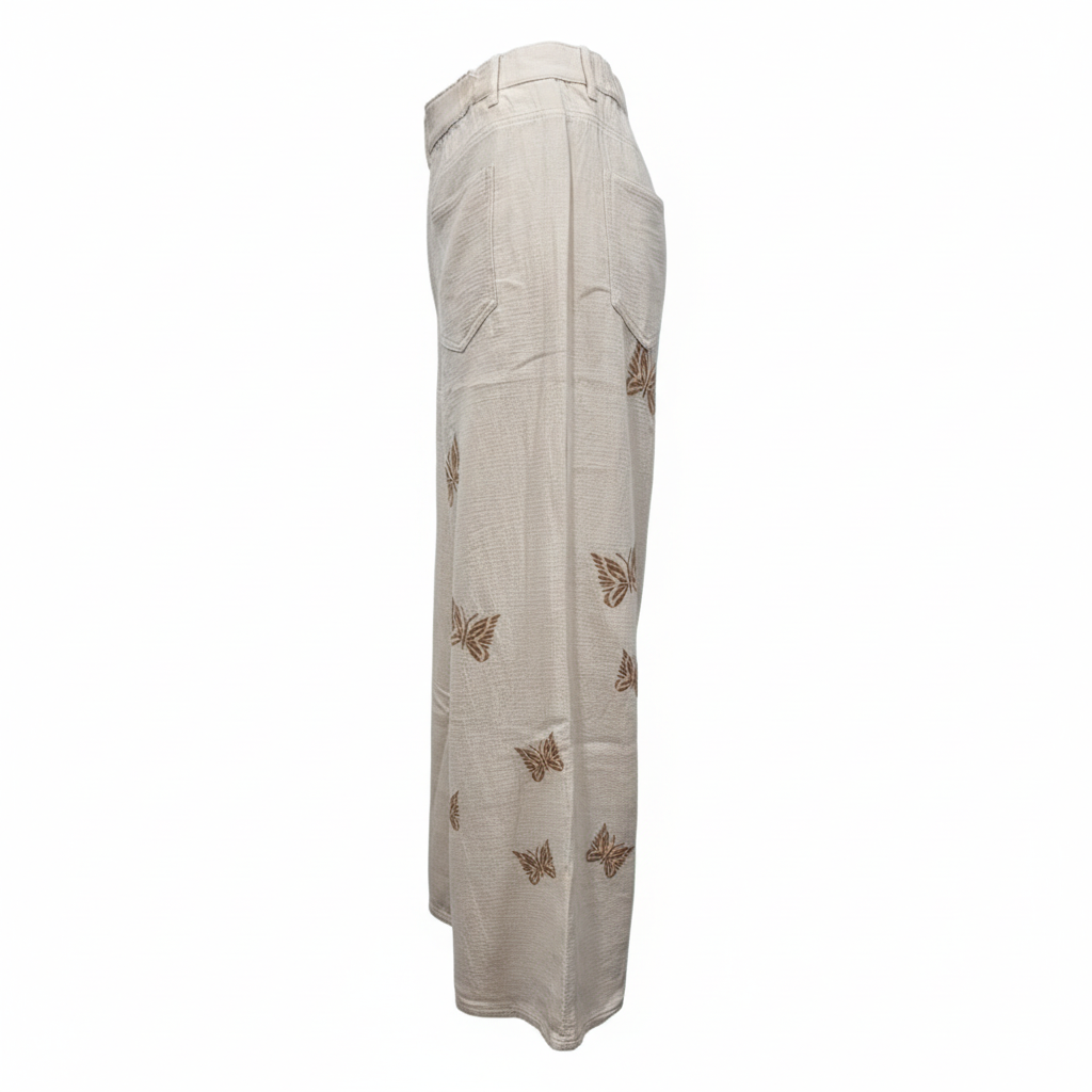 Women's cream wide-leg pants side profile, full-length silhouette, elastic waistband, flowing woven fabric