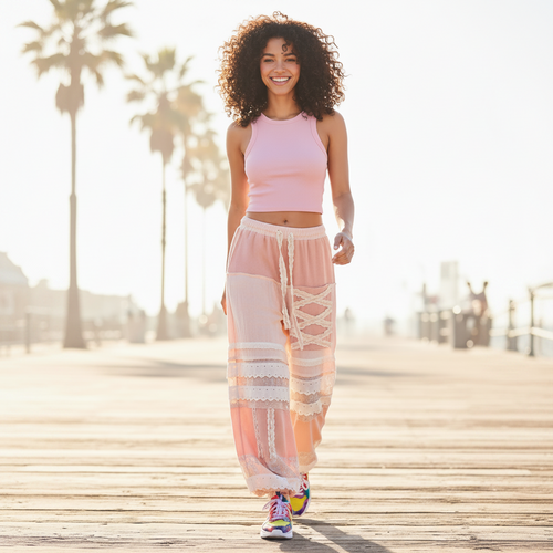 Women's pink eyelet patchwork jogger pants in motion, lightweight gauze fabric, casual street style