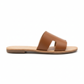 Tan faux leather H-strap flat slide sandal, side profile view showing footbed and flat sole, white background