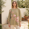 Blue Velvet sage heart patchwork sweatshirt on model in sunlit courtyard, front view showing floral heart appliques
