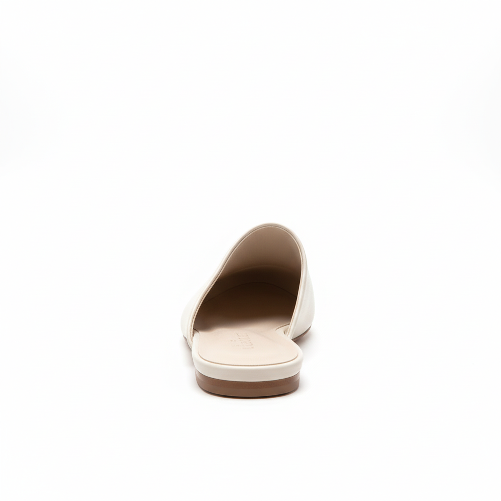 White pointed-toe flat mule - back view showing flat sole and backless slip-on design