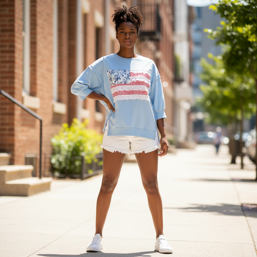 Women's light blue Americana patchwork French terry pullover top, standing lifestyle, styled with white denim shorts - BellanBlue