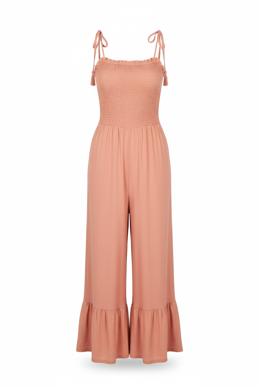 Smocked tie-strap ruffle jumpsuit in coral - front view with thin delicate straps and single ruffle hem