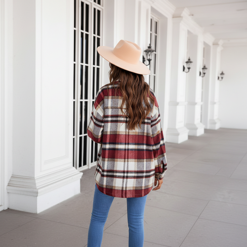 Woman wearing burgundy plaid shacket back view with tan fedora hat lifestyle photo with bokeh background