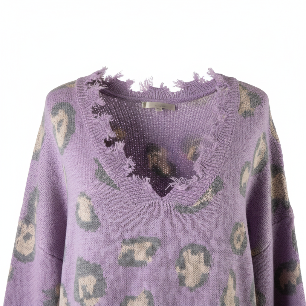 Women's lavender knit sweater close-up, frayed V-neckline detail, grey cream leopard print knit texture