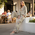 Easel dusty sage floral lounge pants with cargo pocket detail, seated outdoor brunch styling