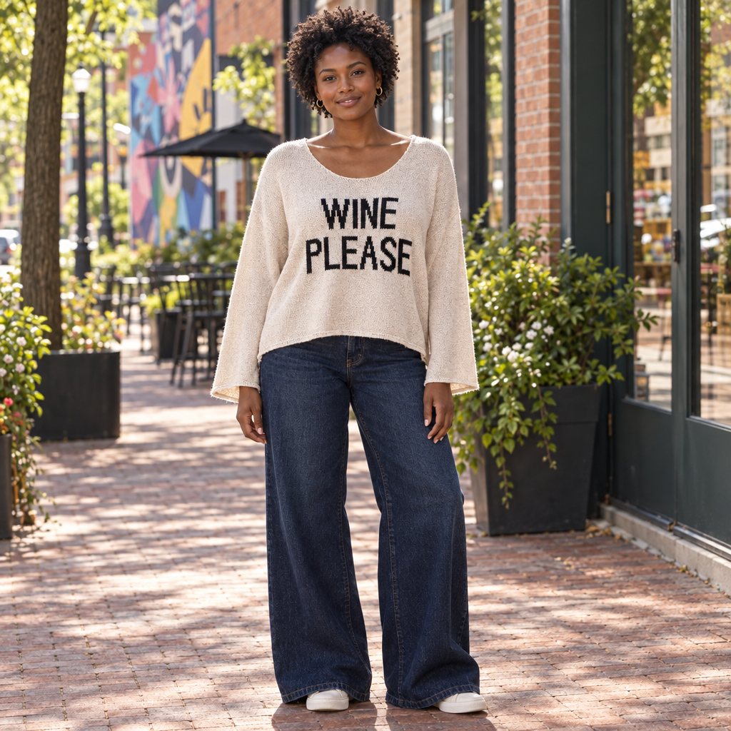 Miracle women's beige Wine Please sweater on a model in jeans on an arts-district sidewalk - BellanBlue