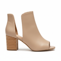 Women's nude faux leather peep toe bootie with chunky stacked cork block heel and side cutouts, side profile view, white background
