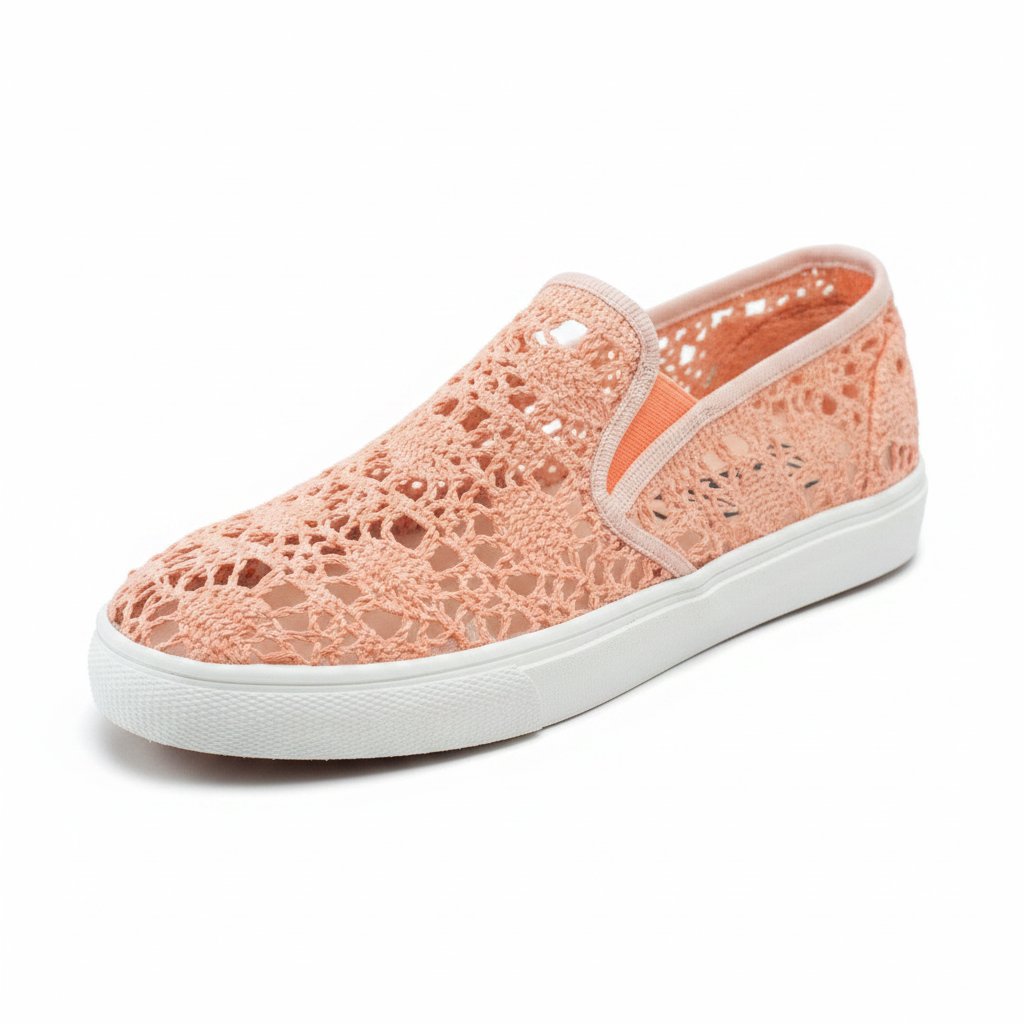 Women's peach open crochet knit sneaker 3/4 front angle view showing mesh texture and white rubber sole