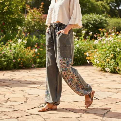 Easel Clothing dirty denim wide-leg pants with colorful crochet side panels, outdoor brunch garden setting