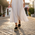 Women's black suede closed toe espadrille flatform sandals with ankle strap styled with linen sundress for a summer Mediterranean street look