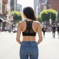 Women's black tattoo mesh racerback bralette back view showing intricate mandala panel styled in city street lifestyle look