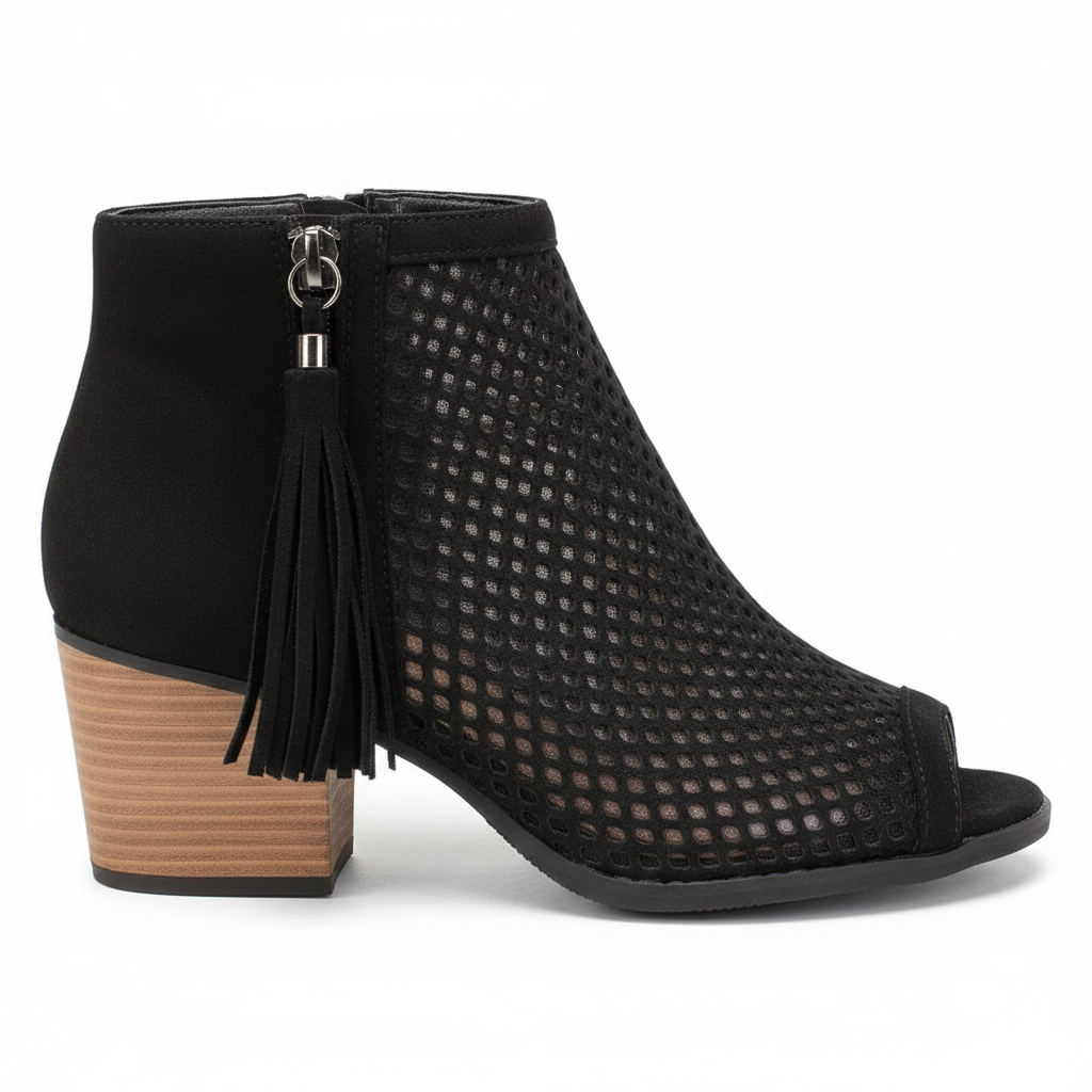 Black perforated peep-toe bootie side profile view showing block heel height and fringe tassel zipper detail on white background
