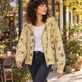 POL Clothing women's lemon floral patchwork zip-up hoodie worn with dark jeans outside a coffee shop