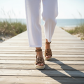 Lifestyle photo of woman wearing leopard print espadrille platform sandals with white linen pants