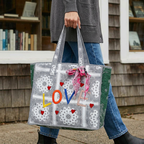 LOVE paisley tote with green side panel carried outside a bookstore