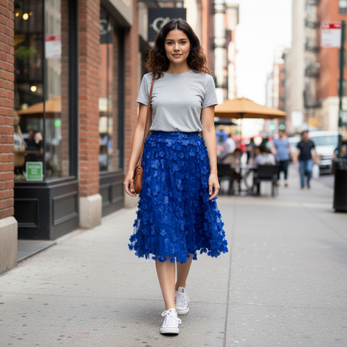 Women's royal blue floral appliqué mesh midi skirt walking on city street full body - BellanBlue