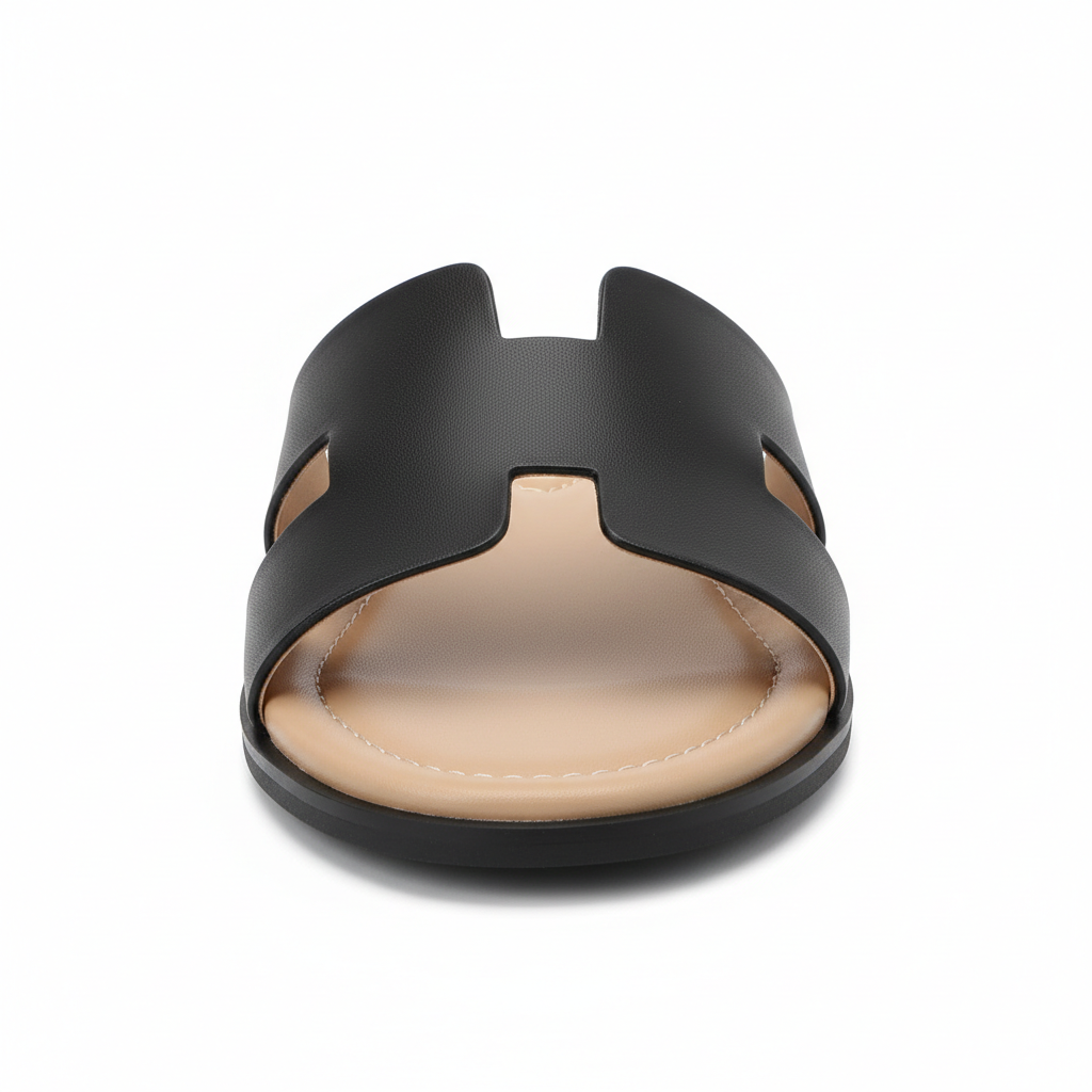 Black H-strap flat slide sandal, front toe view showing cutout band detail, white background