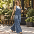 Woman walking in Blue Velvet blue chambray daisy print wide-leg jumpsuit outside a coffee shop