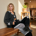 POL Clothing women's black crossover top with peace sign hardware and lace panels, café interior styling