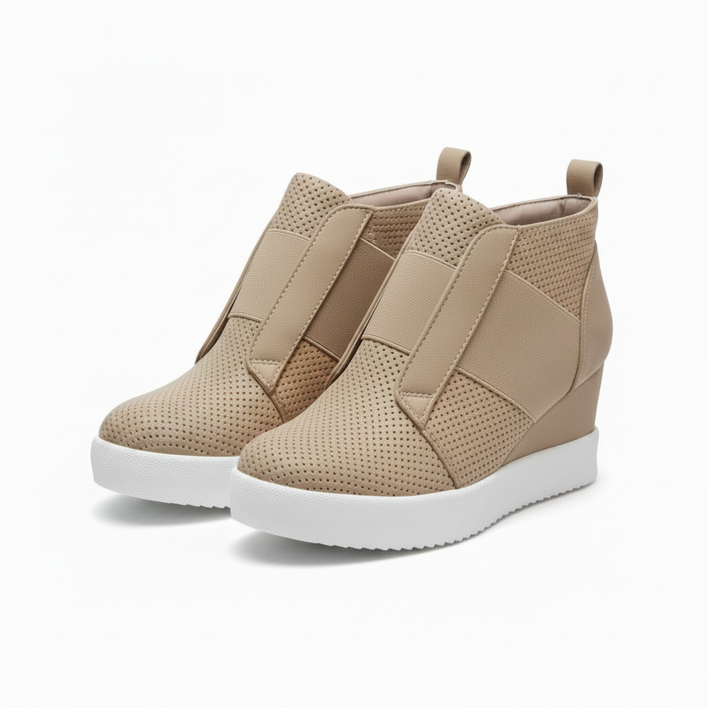 A pair of beige wedge sneakers with perforated leather uppers, elastic side straps, and thick white platform soles, shown against a plain white background.