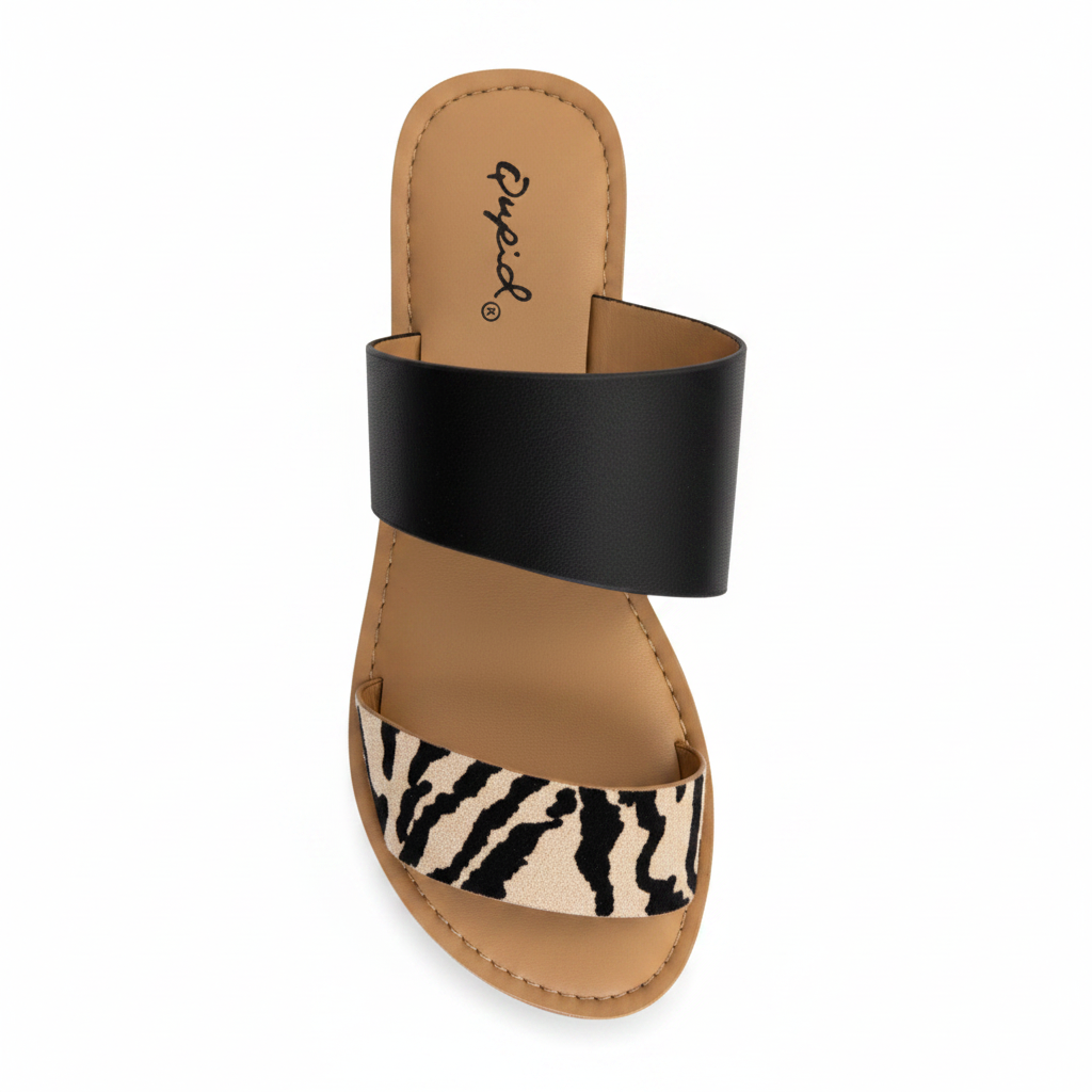 Overhead top view of zebra print double strap slide sandal showing black and white stripes and tan footbed
