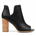 Women's black peep toe bootie with cork block heel and side cutouts, side profile view showing heel height and silhouette