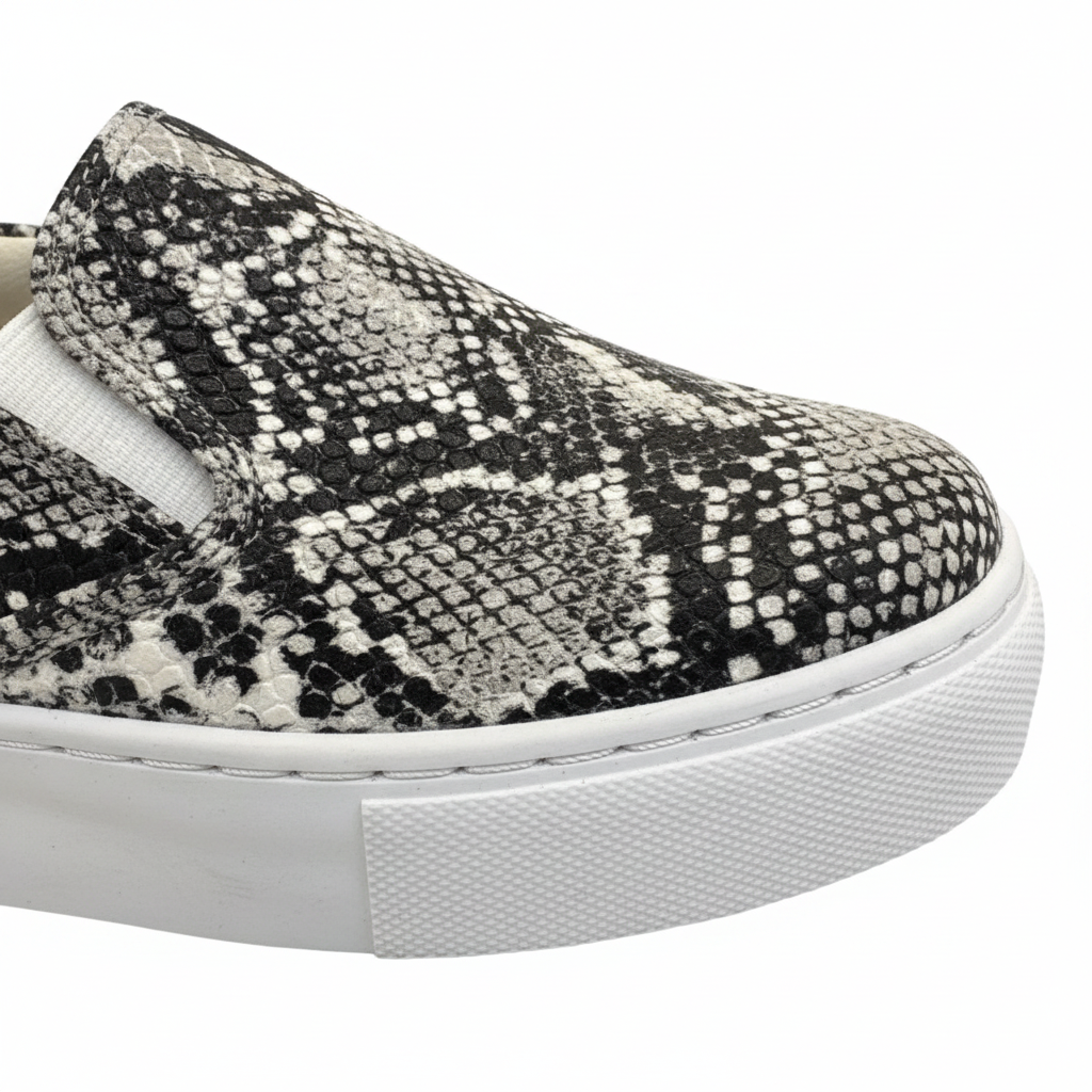 Close-up black white python snakeskin texture detail women's slip-on platform sneaker upper