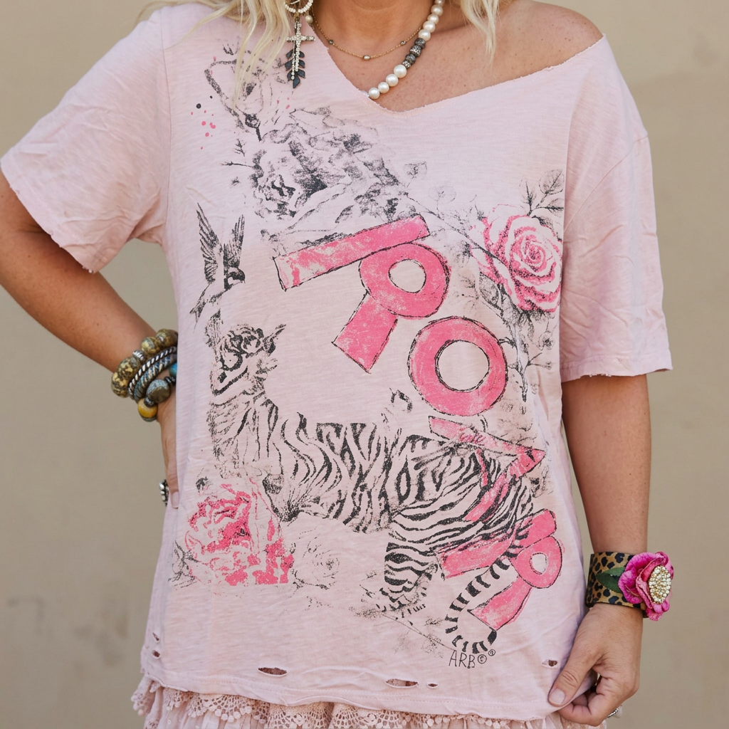 Close view of the tiger sketch, pink block letters and rose collage on a distressed blush pink graphic tee