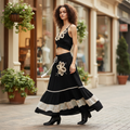 POL Clothing women's black embroidered maxi skirt walking boutique street style, ruffle hem in motion, cream floral detail