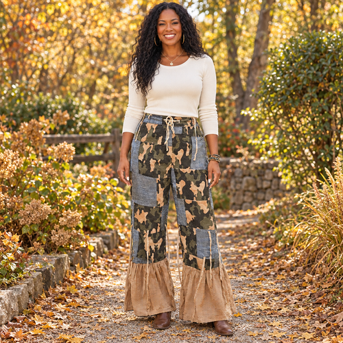 A Rare Bird Shop women's camo patchwork pants with checked ruffle hems on a garden path - BellanBlue