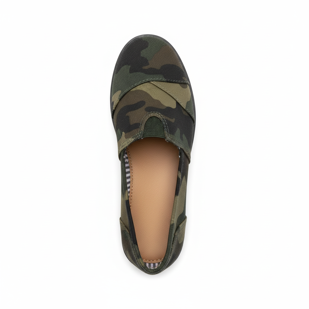 Women's camouflage canvas slip-on flat shoe, top-down overhead view showing camo print upper and striped lining, white background