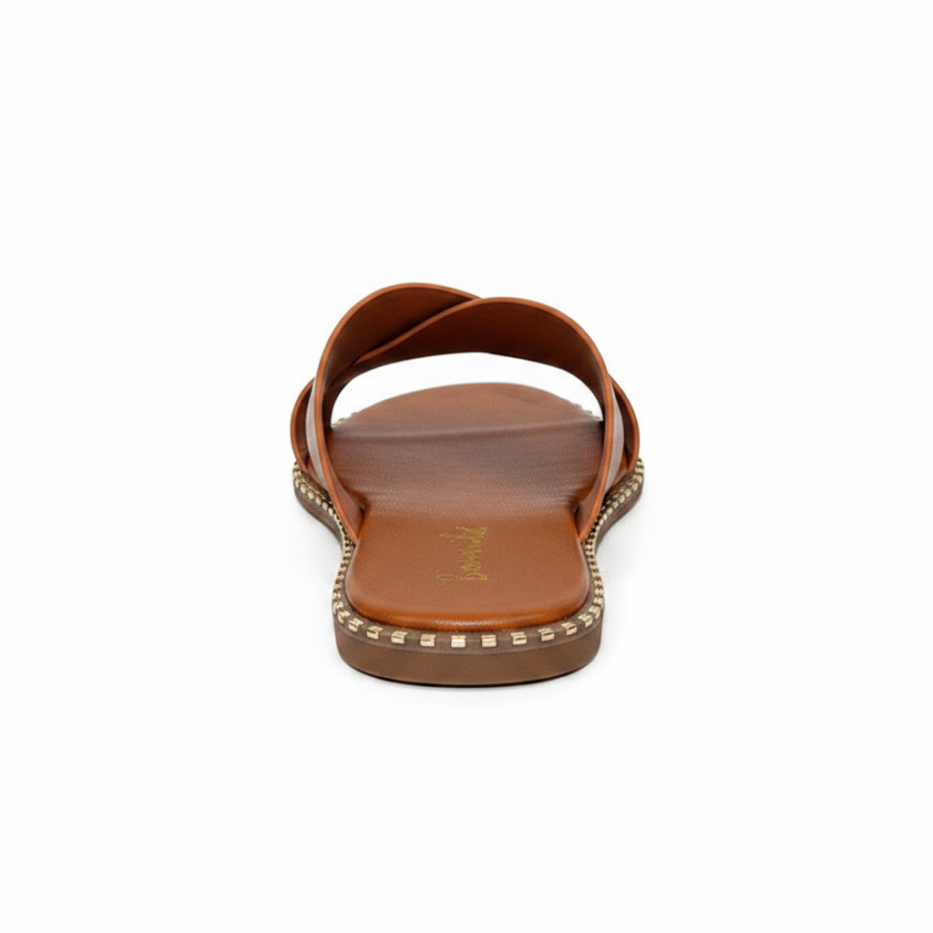 Back view of tan crisscross strap slide sandal showing open heel and gold square stud perimeter detail along dark brown sole