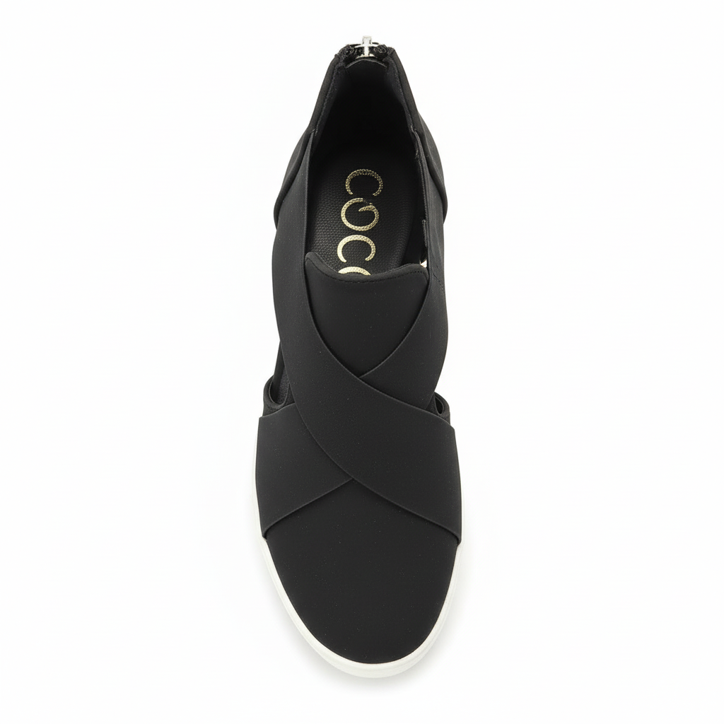 Black slip-on sneakers - top view showing gold branding on insole and crisscross strap design