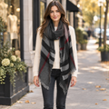 ILLord women's black plaid oblong scarf with fringe, styled on city sidewalk - BellanBlue