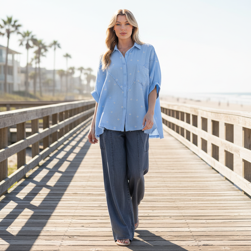 Easel women's sky blue embroidered gauze shirt, walking pose, wide-leg denim, full-length lifestyle view